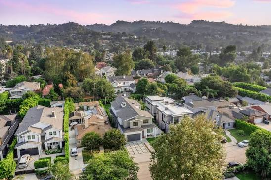 Aerial view of a hillside residential neighborhood at sunset
